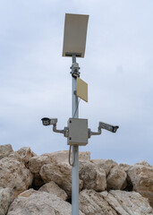 Street surveillanc cameras hang on pole on city embankment. Security concept is control? protection.