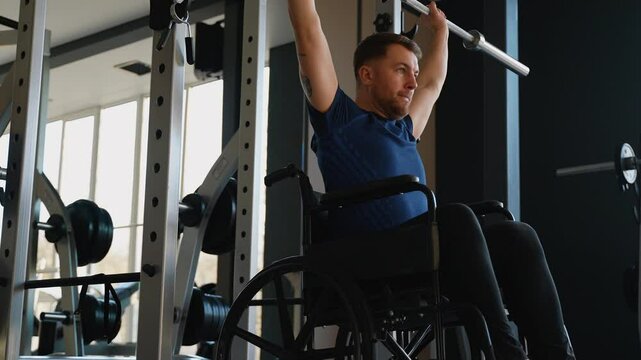Man in wheelchair lifting barbell at gym