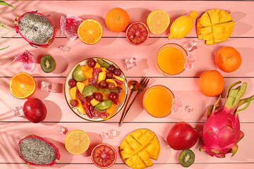 Fruit kitchen background with ingredients for making salad. Dragon fruit, mango, kiwi, orange, nuts and dried apricots, exotic fruits for a healthy lifestyle, advertising banner for a cafe, restaurant