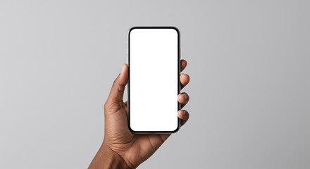 Close-up of dark-skinned hand holding smartphone with blank screen mockup, isolated on gray background with copy space for mobile app or digital product ad