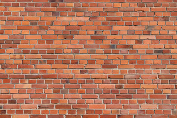 Bright red brick wall with varied tones, minor cracks, textured surface, classic masonry pattern.
