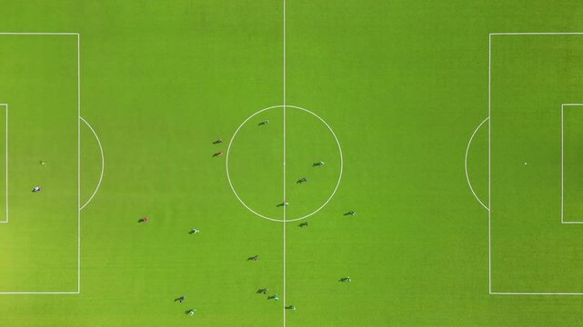 Aerial view of a soccer field with players moving like in a video game