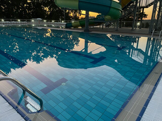 A beautiful view of the water park with colorful slides and a pool on a sunny day. The banner is ready.