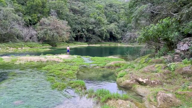 Tourist enjoying the scenic tamul waterfall in san luis potosi, mexico