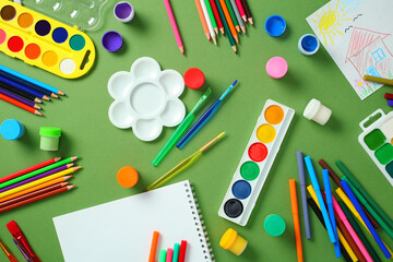Preschool art class supplies: vibrant tools on green desk
