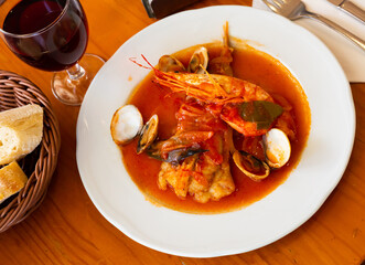Spicy appetizer of monkfish tail a la marinera stewed with vegetables..