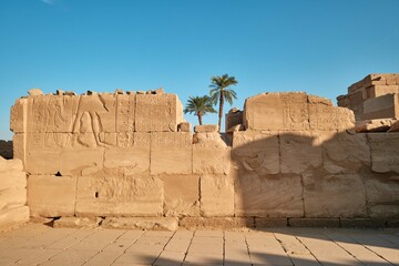 Luxor, Egypt - December 26 2023: Ruins of the Karnak Temple. Stone walls with carved drawings,...