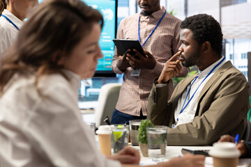 Enterprise manager works with his staff on creating a business strategy and setting goals, studying market dynamics and sales numbers. Corporation team attends a development meeting.