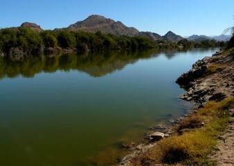 Naklejka premium Pristine River Flowing Through Rocky dry Valley in Richtersveld