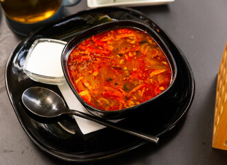 Traditional Russian dish is Solyanka soup, cooked on a steep meat broth. Served with sour cream