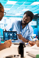 Team of trainee nurses analyzing patient health records during a meeting, utilizing x ray and mri...