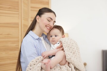 Mother with her cute little baby at home