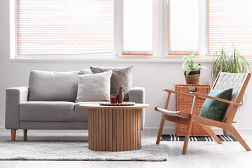 Comfortable armchair, sofa and table in living room