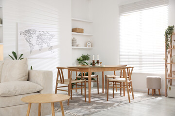 Stylish wooden table with chairs and decor indoors. Interior design