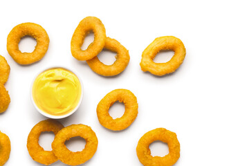 Fried breaded onion rings with mayonnaise on white background