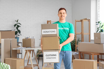 Male volunteer with donation boxes in center