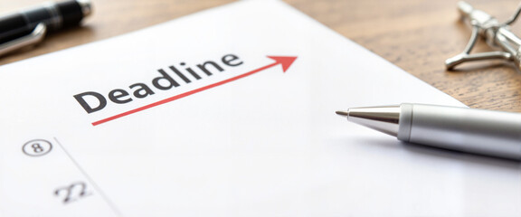 Calendar deadline marked with red arrow on desk, emphasizing urgency