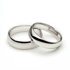 Elegantly crafted wedding rings shine brightly against a pure white backdrop, symbolizing everlasting love and commitment.