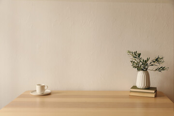 Mediterranean breakfast still life. Cup of coffee, tea, old books on wooden table. Ceramic vase...