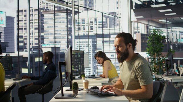 Annoyed programmer at work raging after losing all progress due to computer crash while creating machine learning models. Angry IT worker smashing desk in frustration while programming, camera B