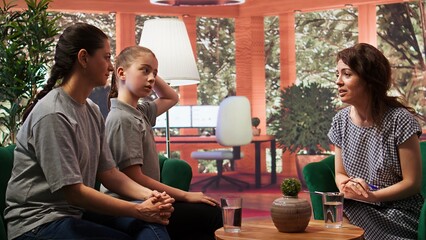 Family therapist offers support and counseling to a troubled teen and her mother. The session focuses on emotional regulation, behavior and mental health strategies for both individuals. Camera B.