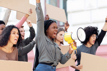 Furious multiracial students with empty placards having strike or demonstration on the street....