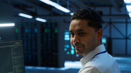 Portrait of smiling data center technician responsible for installation and repair of networking...