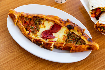 Turkish meat pide on plate. Juicy homemade food