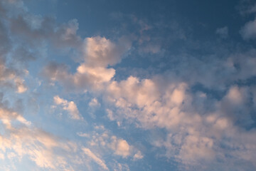 Blue Sky with Wispy Clouds at Sunset. This sky photo is perfect for backgrounds, themes of tranquility, nature, or freedom, and can be used in designs related to relaxation, inspiration or the outdoor