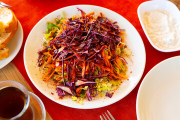 Traditional Turkish kebab salad of shredded white and red cabbage, carrots dressed with olive oil and seasoned richly with piquant tart sumac