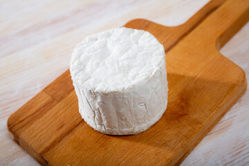 Image of blue cheese with mold at wooden board, nobody