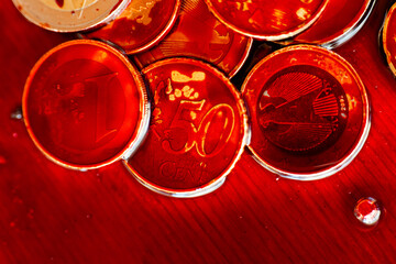 Bloody criminal finance.red blood on coins close up.Money drowns in blood. Blood and money.Money...