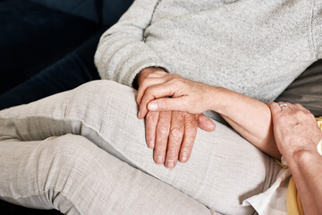 Senior couple holding hands for love, support and trust for gratitude, empathy and care in retirement at home. Closeup, partner and helping hand for loyalty, kindness and relax together in marriage