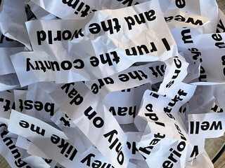 Word salad jumble of crumpled strips of paper with words and phrases