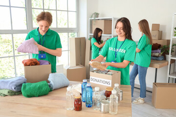 Young volunteers with donations for poor people in center