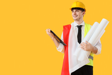 Male architect with flag of Poland on yellow background