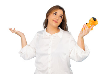 Young businesswoman holding a small toy and shrugging, showing uncertainty and confusion, on a...