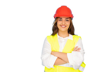 Confident female architect smiles with crossed arms, wearing safety vest and hardhat, on a...