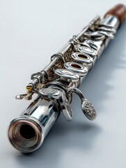 A detailed view of a silver flute showcasing its keys and craftsmanship.