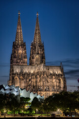 the majestic Cologne cathedral in the blue hour illuminated by the newly installed LED lighting in...