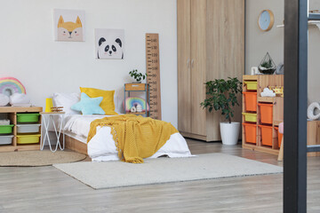 Interior of children's room with bed, shelves and toys