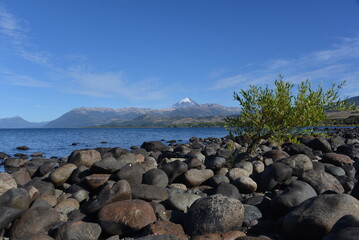 beach of lago huechulafquen and peak of lanin volcano at lanin national park, patagonia, argentina