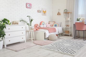 Obraz premium Interior of stylish children's room with bed, study table and drawers