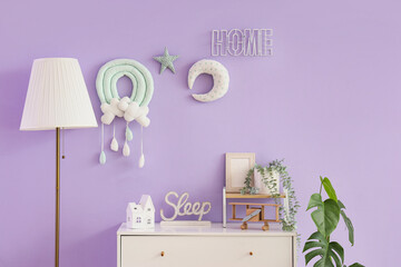 Interior of nursery with commode, lamp and toys