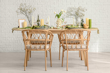 Elegant table setting with beautiful flowers and candles in light dining room
