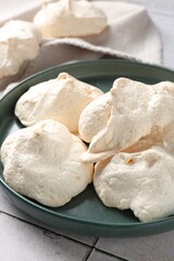 Delicious homemade meringue cookies on table, closeup