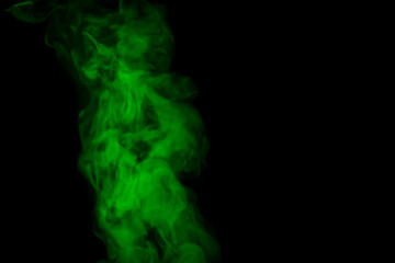 Obraz premium Bright green smoke in air on black background, space for text
