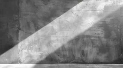 empty concrete wall illuminated by diagonal beam of natural sunlight creating strong contrast and textured shadow patterns, evoking a calm and minimalistic atmosphere