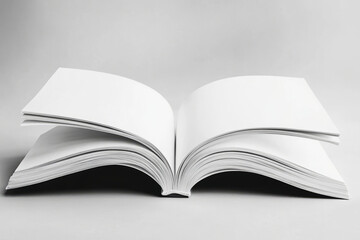 Obraz premium open blank book on gray background, minimalistic concept for creativity and imagination