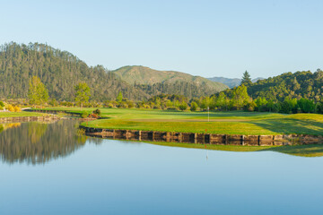 waterway winding through landscape past golf course green
